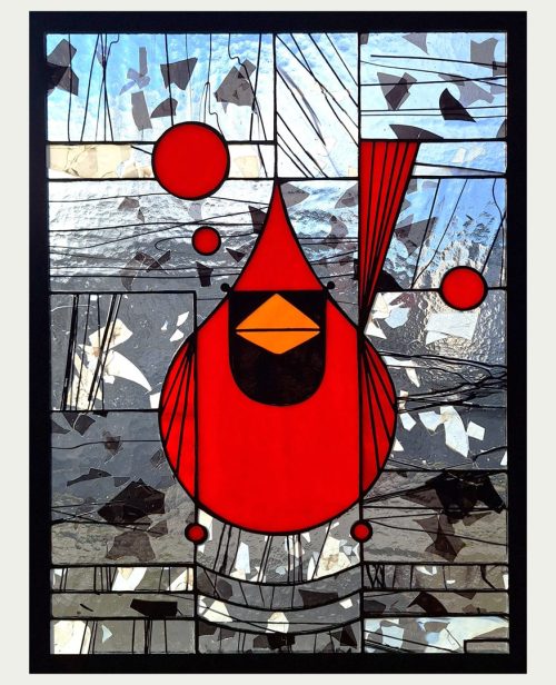 A stained glass window panel of a cardinal by Hinnenkamp Glass Crafters.