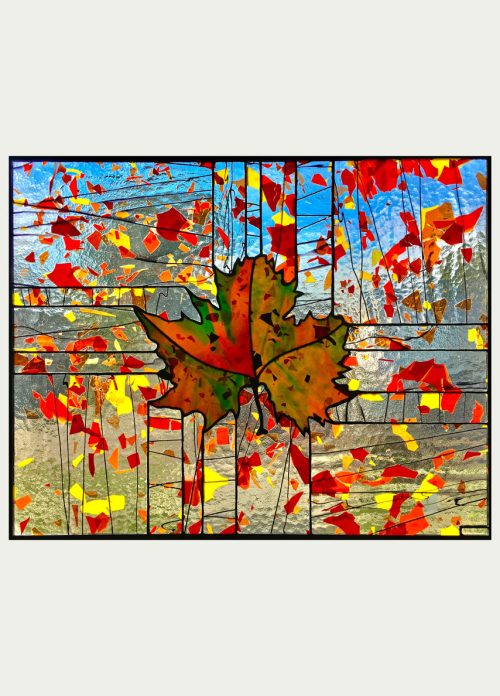 A stained glass window panel titled Fractured Fall by Hinnenkamp Glass Crafters.